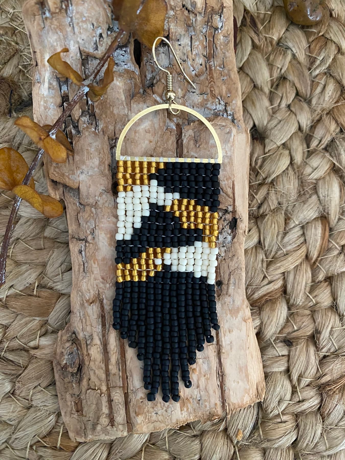 Black, cream, and gold hand-beaded fringe earring