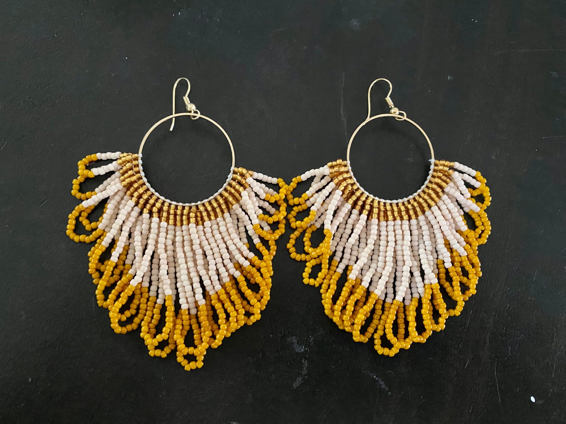 Pair of cream, gold, and yellow looped-bead earrings